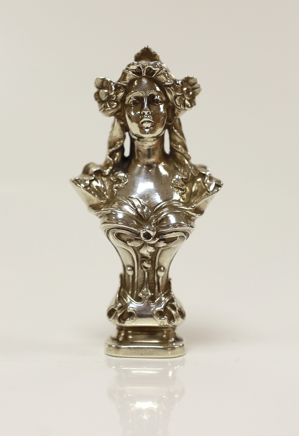 An early 20th century Art Nouveau silver seal, modelled as the bust of a lady, import marks for Berthold Muller, Chester, 1901, height 93mm, the matrix carved with family crest.